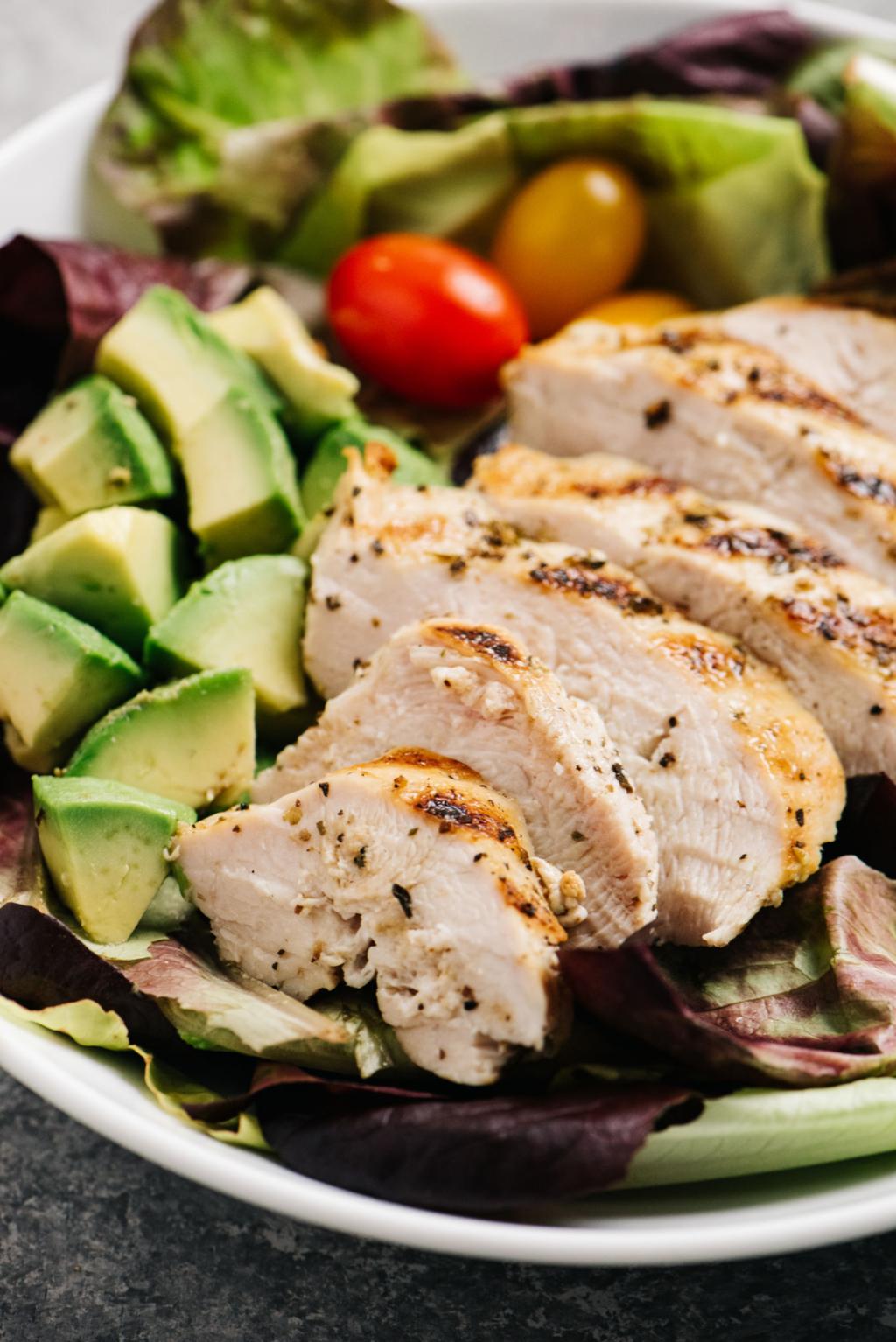 healthy paleo diet food with grilled chicken avocado and natural whole ingredients