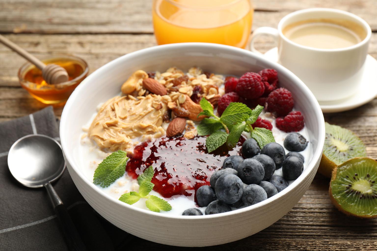 healthy vegetarian breakfast with berries nuts yogurt and plant based ingredients