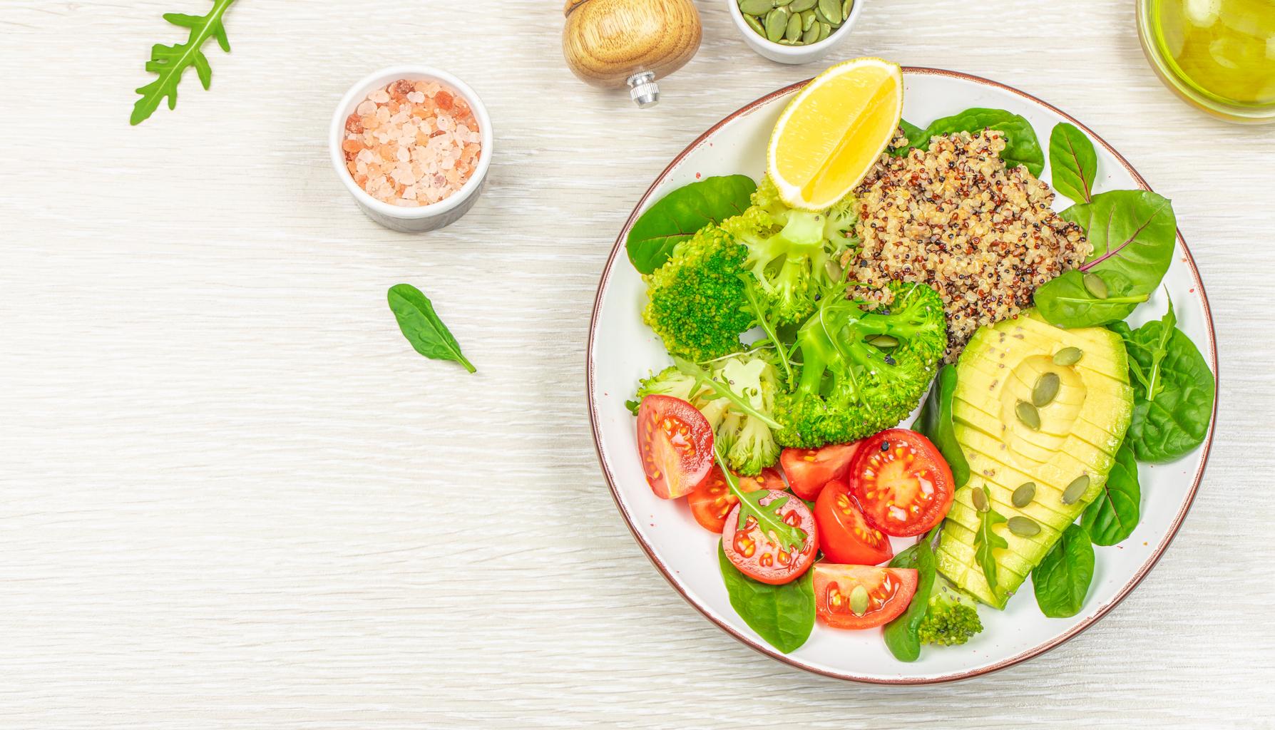 healthy vegetarian meal with avocado quinoa broccoli and fresh vegetables
