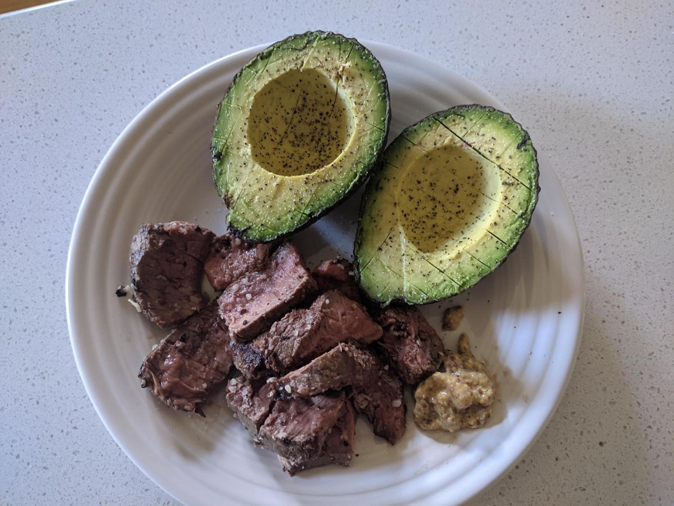 low carb keto diet meal with grilled steak and fresh avocado